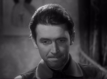 Movie still from “Destry Rides Again” (1939), directed by George Marshall – A black and white photo of a man in a tie; Close Up shot, High angle