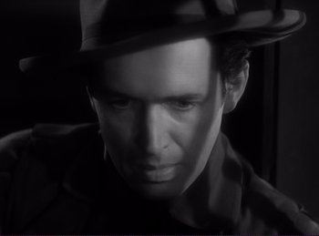Movie still from “Destry Rides Again” (1939), directed by George Marshall – A black and white photo of a man wearing a hat; Close Up shot, High angle