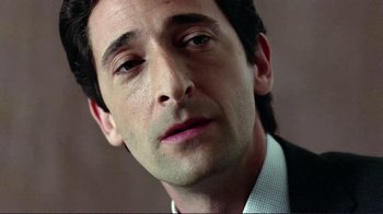 Movie still from “Detachment” (2011), directed by Tony Kaye – A person wearing a suit and tie; Close Up shot, Low angle