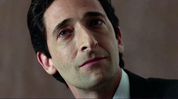 Movie still from “Detachment” (2011), directed by Tony Kaye – A person wearing a suit and tie; Close Up shot, Low angle