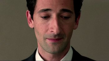 Movie still from “Detachment” (2011), directed by Tony Kaye – A person wearing a suit and tie; Close Up shot, Low angle
