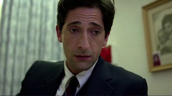 Movie still from “Detachment” (2011), directed by Tony Kaye – A person wearing a suit and tie; Close Up shot, High angle