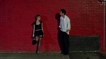 Movie still from “Detachment” (2011), directed by Tony Kaye – A man and a woman standing next to each other on a sidewalk; Medium shot, Low angle