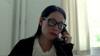 Movie still from “Detachment” (2011), directed by Tony Kaye – A woman wearing glasses talking on a phone; Close Up shot, High angle