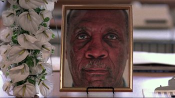 Movie still from “Detachment” (2011), directed by Tony Kaye – A picture of a man's face in front of a white flower; Extreme Close Up shot, Low angle