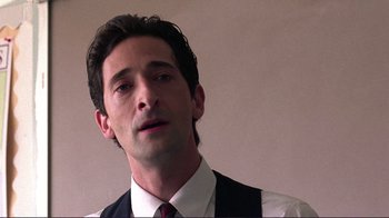 Movie still from “Detachment” (2011), directed by Tony Kaye – A person wearing a suit and tie; Close Up shot, Low angle