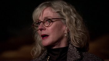 Movie still from “Detachment” (2011), directed by Tony Kaye – An older woman with blonde hair wearing glasses; Close Up shot, Low angle