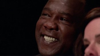 Movie still from “Detachment” (2011), directed by Tony Kaye – A person smiling with his mouth wide open; Close Up shot, Low angle