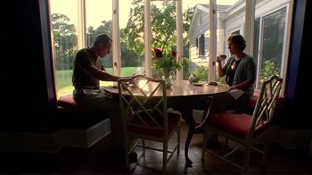 Movie still from “Detachment” (2011), directed by Tony Kaye – Two people sitting at a table in front of a window; Wide shot, Low angle
