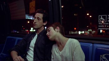 Movie still from “Detachment” (2011), directed by Tony Kaye – A man and a woman sitting next to each other on a bus; Medium shot, High angle
