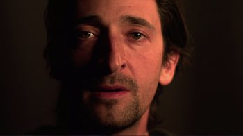 Movie still from “Detachment” (2011), directed by Tony Kaye – A man's face in the dark; Close Up shot, Low angle