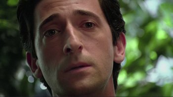 Movie still from “Detachment” (2011), directed by Tony Kaye – A man's face with trees in the background; Close Up shot, Low angle