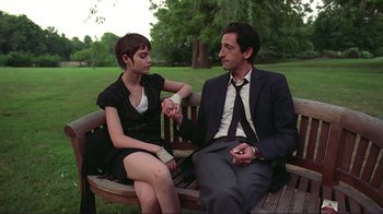 Movie still from “Detachment” (2011), directed by Tony Kaye – A man and a woman sitting on a wooden bench; Medium shot, Over the shoulder angle