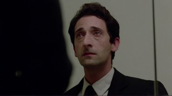 Movie still from “Detachment” (2011), directed by Tony Kaye – A person wearing a suit and tie; Close Up shot, Low angle