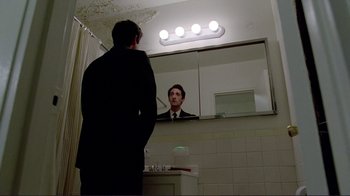 Movie still from “Detachment” (2011), directed by Tony Kaye – A man standing in front of a mirror in a bathroom; Medium shot, Low angle