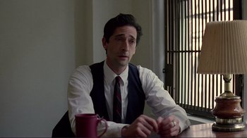 Movie still from “Detachment” (2011), directed by Tony Kaye – A man sitting at a table with a coffee mug; Close Up shot, Over the shoulder angle