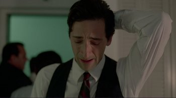 Movie still from “Detachment” (2011), directed by Tony Kaye – A man in a vest and tie holding his head; Close Up shot, High angle