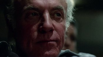 Movie still from “Detachment” (2011), directed by Tony Kaye – An older man with a white beard looking into the camera; Close Up shot, Low angle