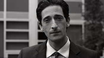 Movie still from “Detachment” (2011), directed by Tony Kaye – Black and white photograph of a man wearing a suit and tie; Close Up shot, Low angle