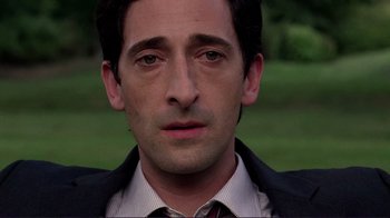 Movie still from “Detachment” (2011), directed by Tony Kaye – A person wearing a suit and tie; Close Up shot, High angle
