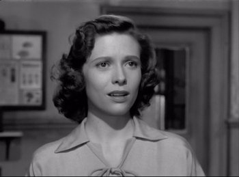 Movie still from “Detective Story” (1951), directed by William Wyler – An old black and white photo of a woman; Close Up shot, Low angle