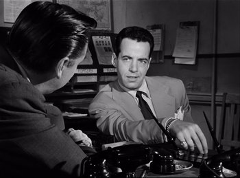 Movie still from “Detective Story” (1951), directed by William Wyler – A black and white photo of a man and a woman; Medium shot, Over the shoulder angle