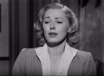 Movie still from “Detective Story” (1951), directed by William Wyler – A black and white photo of a woman in a suit; Close Up shot, Low angle