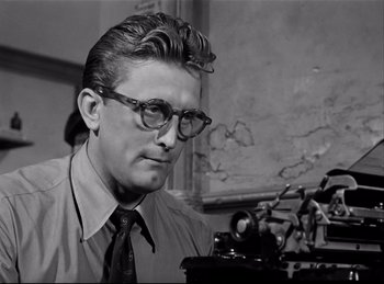 Movie still from “Detective Story” (1951), directed by William Wyler – A man with glasses is looking at a typewriter; Close Up shot, Low angle