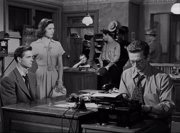 Movie still from “Detective Story” (1951), directed by William Wyler – A group of people sitting at a table; Medium shot, Low angle