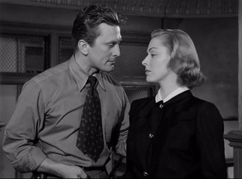 Movie still from “Detective Story” (1951), directed by William Wyler – A man and a woman standing next to each other; Medium shot, Low angle