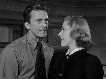 Movie still from “Detective Story” (1951), directed by William Wyler – A man and a woman standing next to each other; Medium shot, Low angle