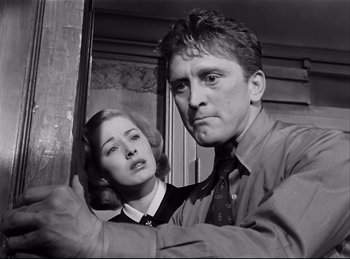 Movie still from “Detective Story” (1951), directed by William Wyler – A man and a woman posing for a picture; Close Up shot, Low angle