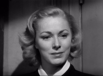 Movie still from “Detective Story” (1951), directed by William Wyler – A black and white photo of a woman's face; Close Up shot, Low angle