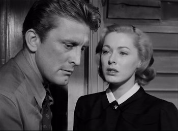 Movie still from “Detective Story” (1951), directed by William Wyler – A black and white photo of a man and a woman looking at each other; Close Up shot, Low angle