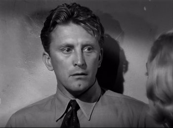 Movie still from “Detective Story” (1951), directed by William Wyler – A man in a dress shirt and a tie; Close Up shot, Over the shoulder angle