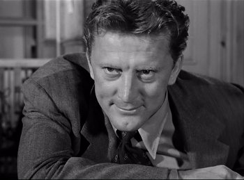 Movie still from “Detective Story” (1951), directed by William Wyler – Black and white photograph of a man wearing a suit; Close Up shot, Low angle