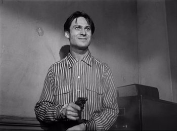 Movie still from “Detective Story” (1951), directed by William Wyler – A black and white photo of a man holding a cell phone; Close Up shot, Low angle