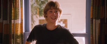 Movie still from “Detroit Rock City” (1999), directed by Adam Rifkin – A young man smiles for the camera; Close Up shot, Low angle