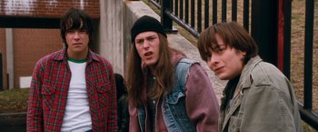 Movie still from “Detroit Rock City” (1999), directed by Adam Rifkin – A group of young men standing next to a railing; Medium shot, Low angle