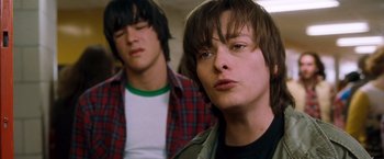 Movie still from “Detroit Rock City” (1999), directed by Adam Rifkin – Two young men standing next to each other in a room; Close Up shot, Low angle