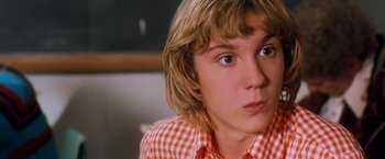 Movie still from “Detroit Rock City” (1999), directed by Adam Rifkin – A person wearing a checkered shirt; Close Up shot, Over the shoulder angle