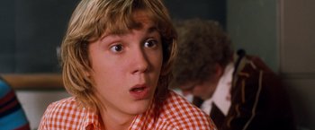 Movie still from “Detroit Rock City” (1999), directed by Adam Rifkin – A person wearing a checkered shirt; Close Up shot, Low angle