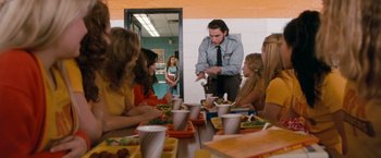 Movie still from “Detroit Rock City” (1999), directed by Adam Rifkin – A group of people sitting at a table with food; Medium shot, Over the shoulder angle