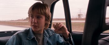 Movie still from “Detroit Rock City” (1999), directed by Adam Rifkin – A person sitting in the back of a car; Close Up shot, Over the shoulder angle