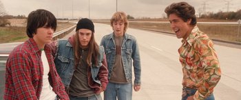 Movie still from “Detroit Rock City” (1999), directed by Adam Rifkin – Two young people walking down the street together; Medium shot, Over the shoulder angle