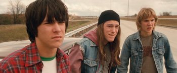 Movie still from “Detroit Rock City” (1999), directed by Adam Rifkin – A group of young men standing next to each other on the side of a road; Close Up shot, Over the shoulder angle