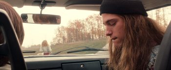 Movie still from “Detroit Rock City” (1999), directed by Adam Rifkin – A man sitting in a car with his eyes closed; Close Up shot, Low angle