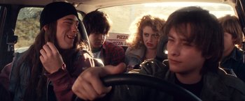 Movie still from “Detroit Rock City” (1999), directed by Adam Rifkin – A group of people in the back of a car; Medium shot, Over the shoulder angle