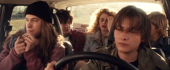 Movie still from “Detroit Rock City” (1999), directed by Adam Rifkin – A group of people sitting in the back of a car; Medium shot, Over the shoulder angle