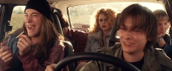 Movie still from “Detroit Rock City” (1999), directed by Adam Rifkin – A group of people sitting in the back of a car; Medium shot, Over the shoulder angle